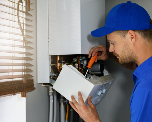 A specialist carrying out a servicing on a boiler